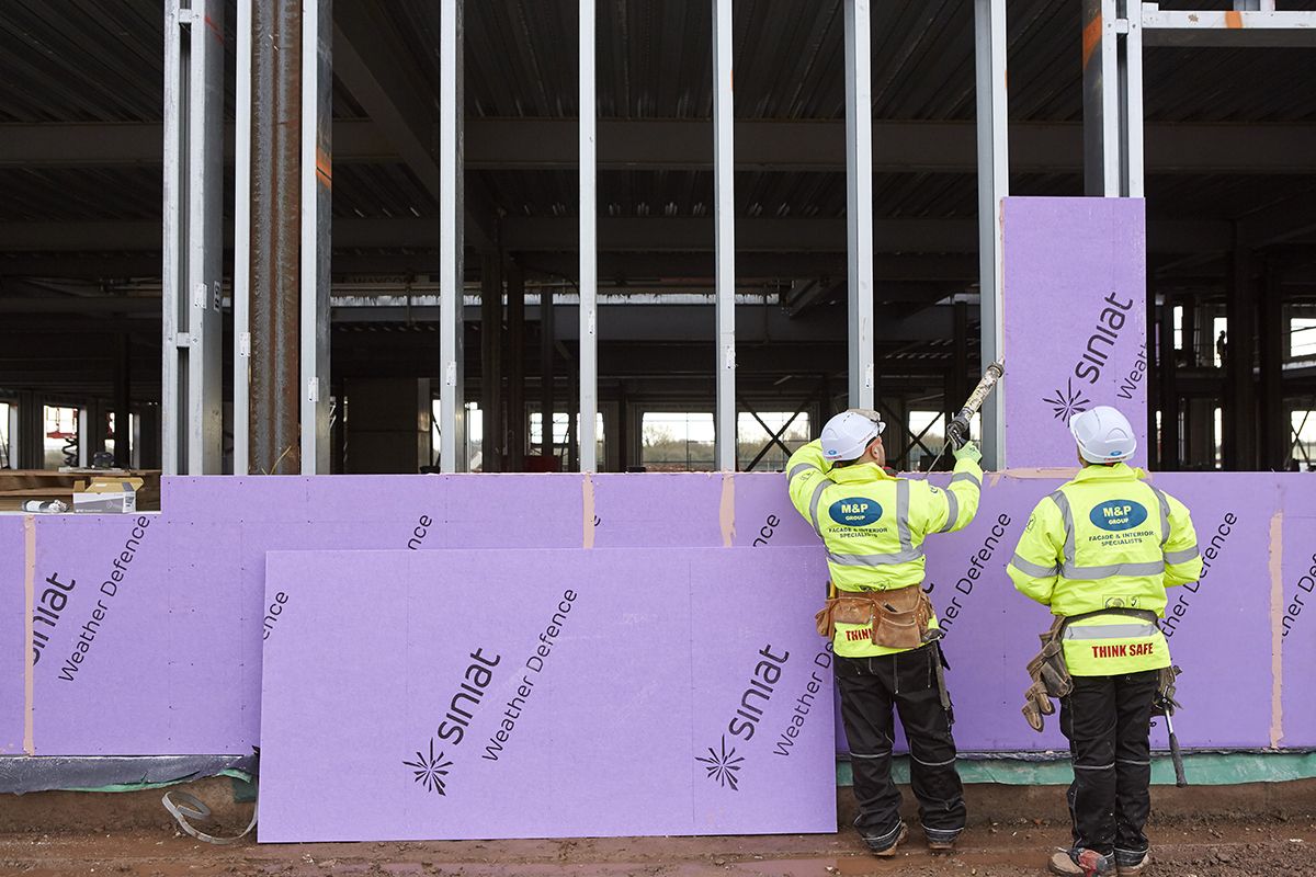 installer-fixing-siniat-boards-to-frames-eastern-high-school-which-has-been-designed-by-powell-dobson